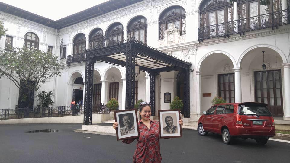Photo of Michelle with her drawings